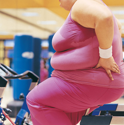 Unhappy large woman on treadmill
